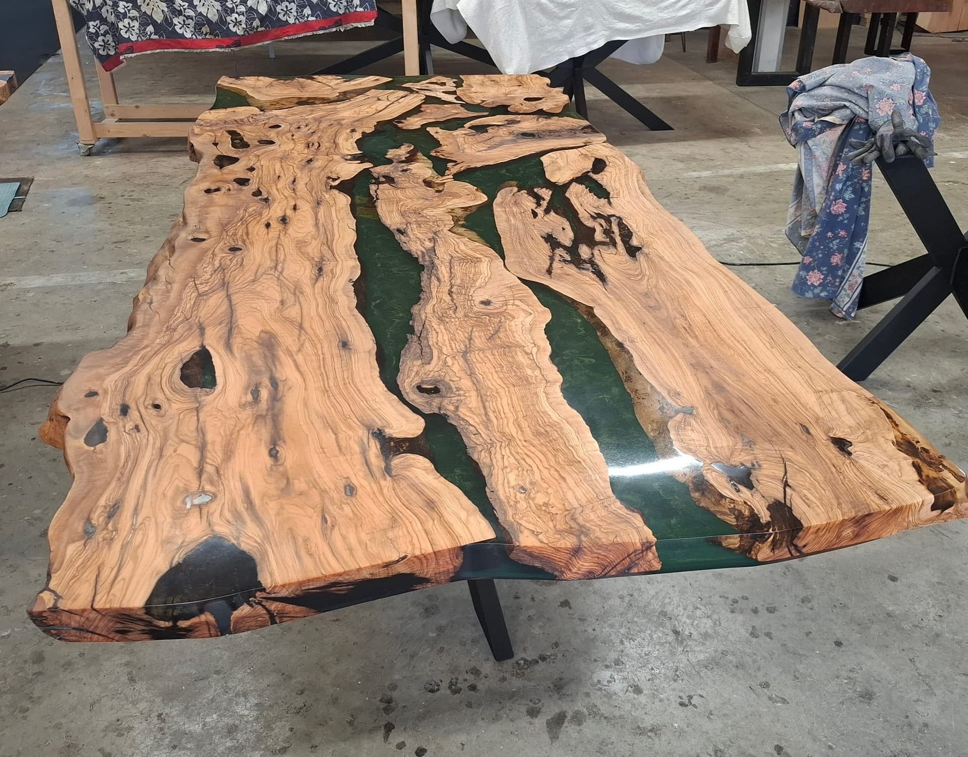 Olive-wood dining table with a green epoxy river